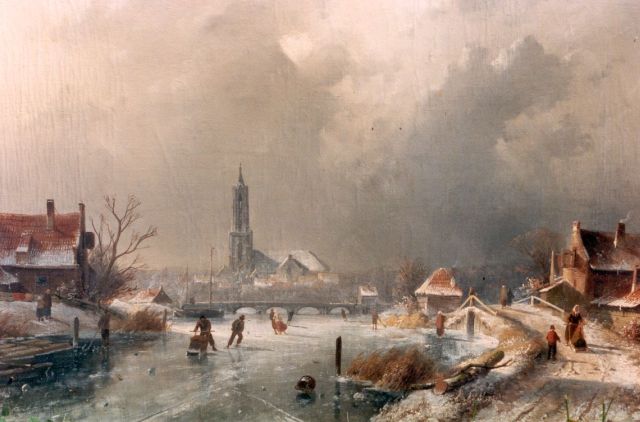 Leickert C.H.J.  | A winter landscape with skaters on the ice, Amersfoort in te distance, oil on canvas 44.3 x 65.6 cm, signed l.l.